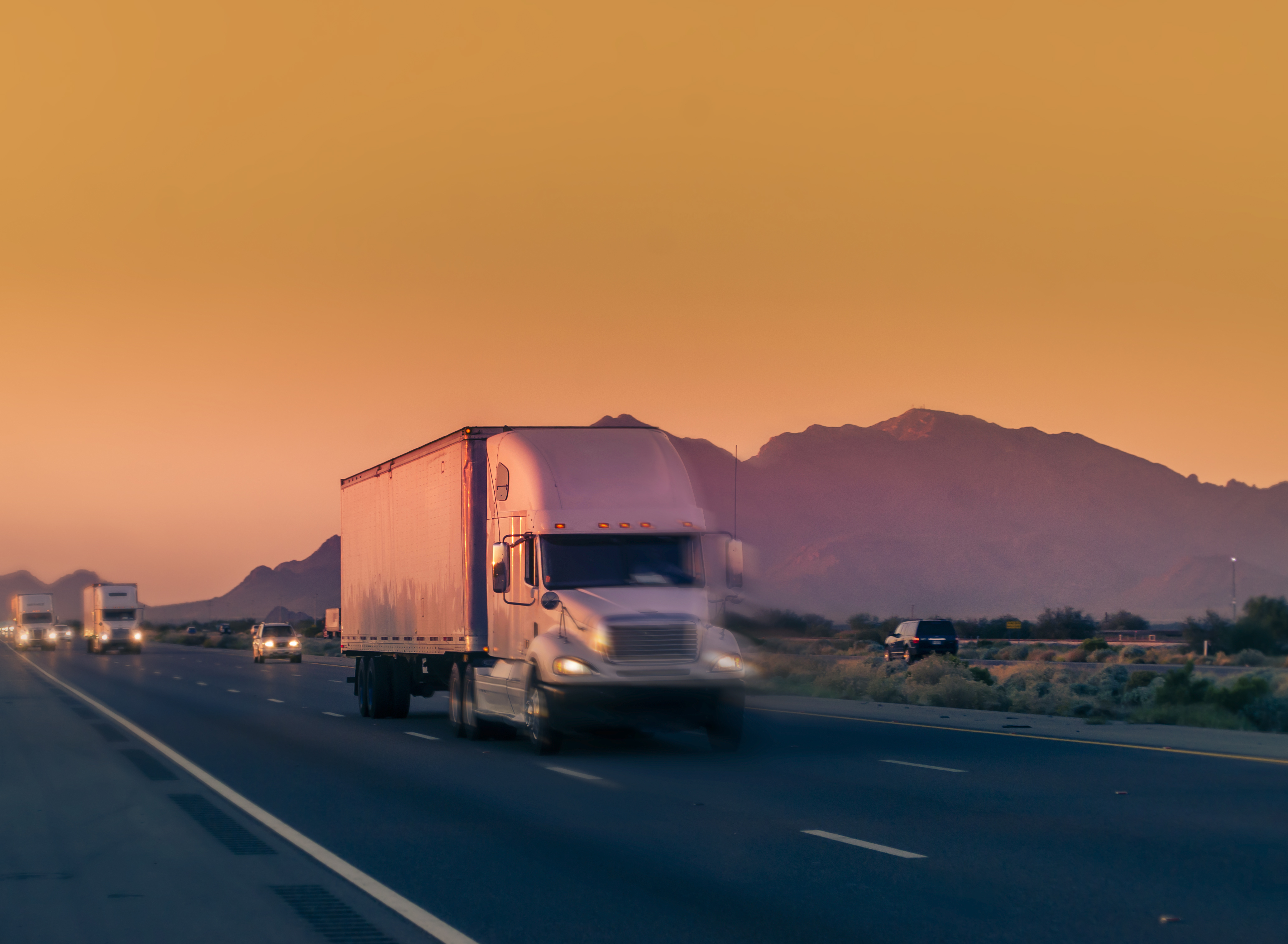 truck-driving-desert-sunset